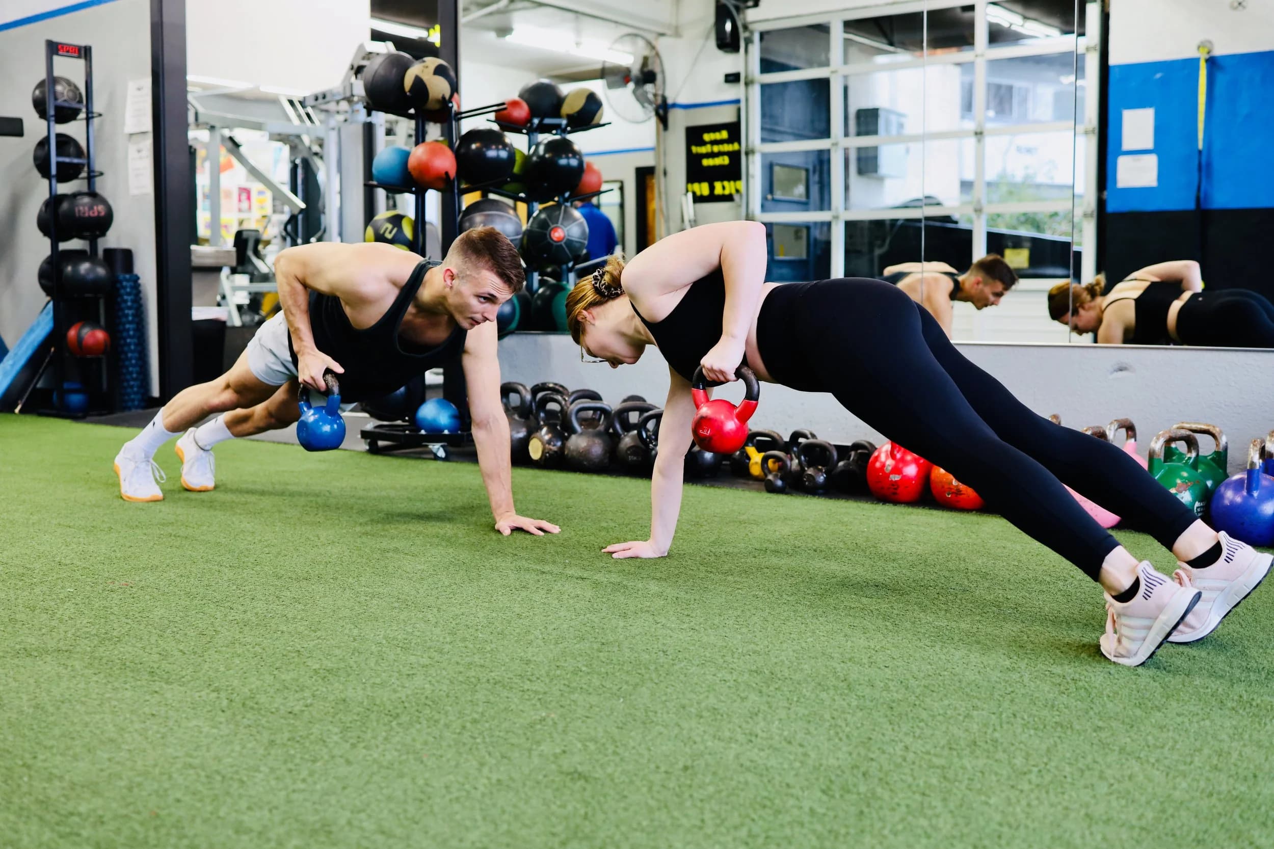 Member performing kettlebell rows